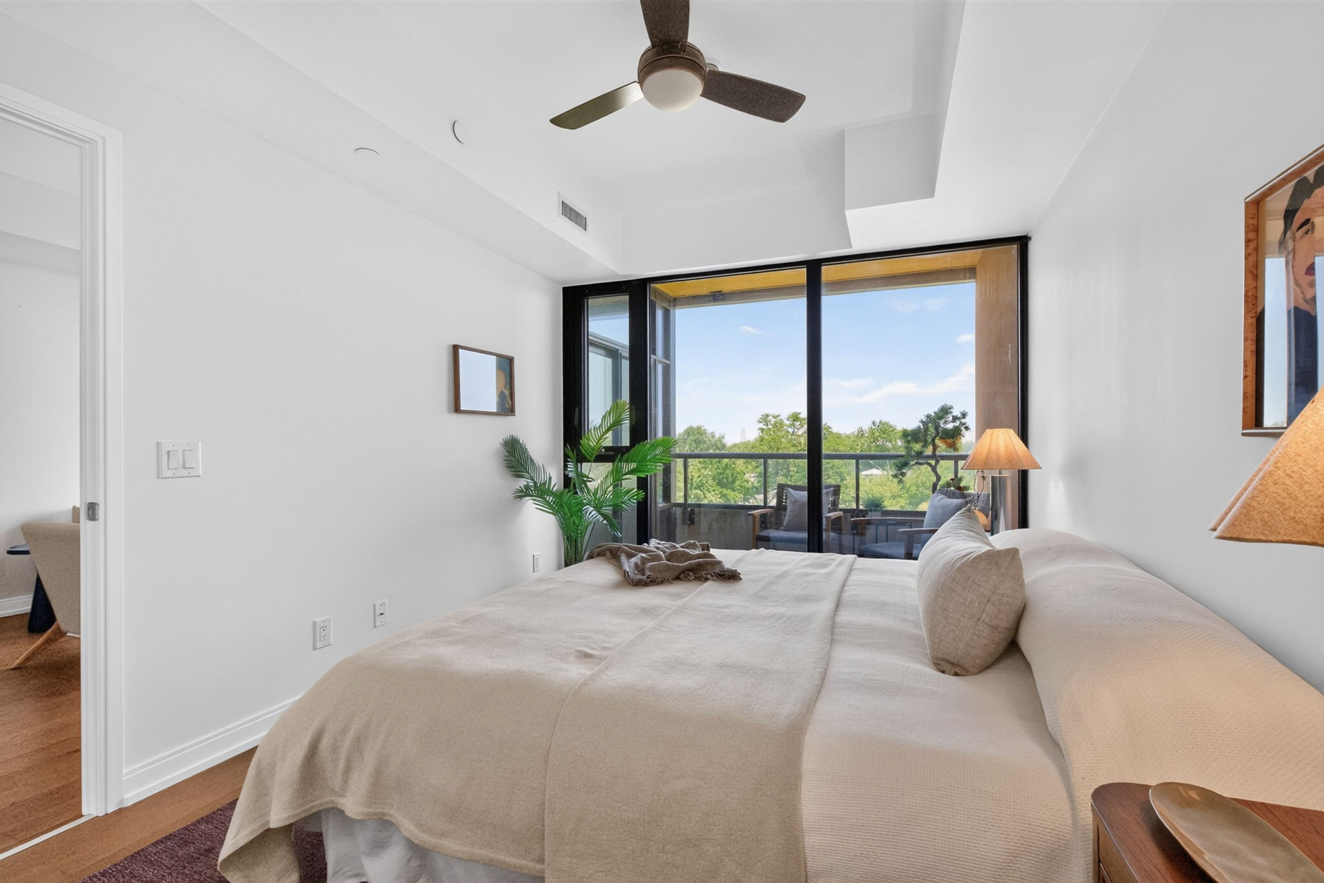 Primary bedroom with leafy outlook and balcony