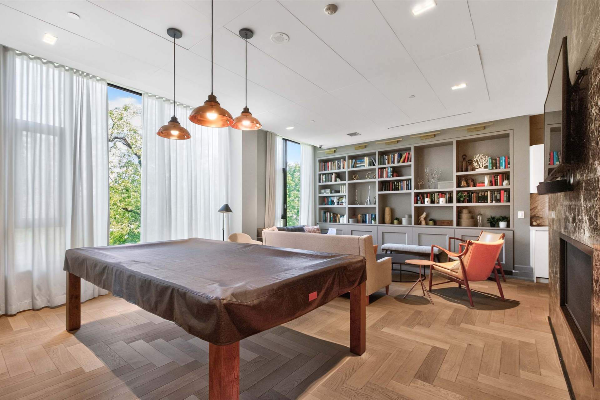 Party room with billiards table, built-in library and fireplace