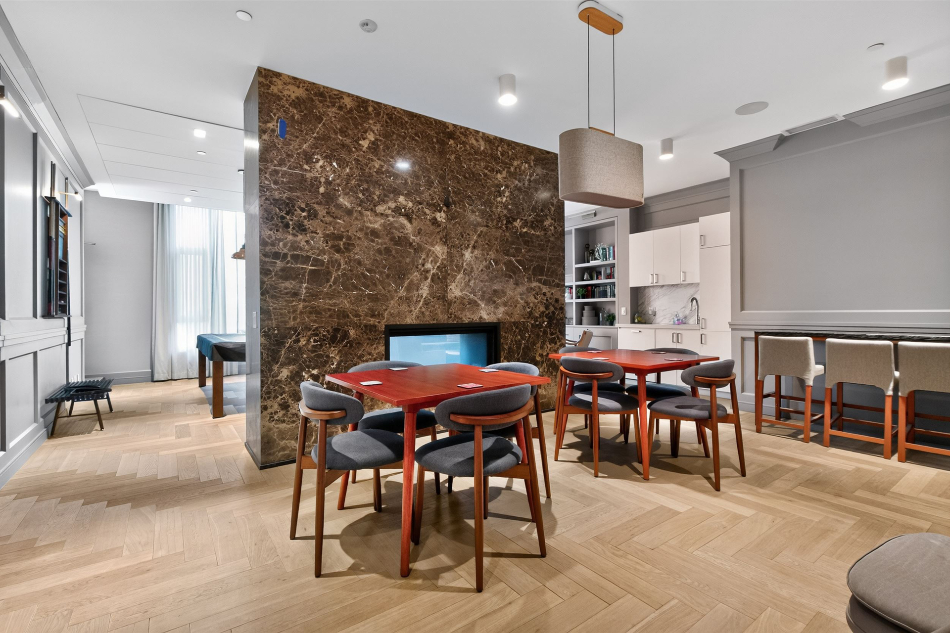 Party room games area with card tables and bar seating